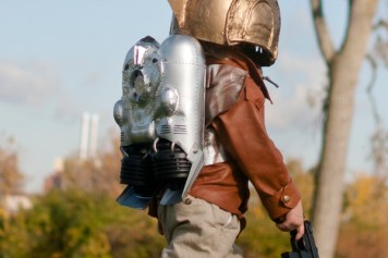 kid with helmet, rocket on back and weapon in hand