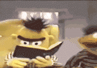 Image of Bert raising his head from a book with an expression of revelation