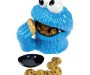 Cookie jar shaped like the cookie monsters head, with the cookies in his mouth and a hand reaching up to feed him another cookie