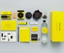 Just in Case kit laid out in bright canary yellow. Showing a bottle of water, knife, alcohol, chocolate, notebook, pen, matches and guide book.
