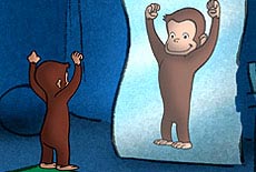 Little monkey stands in front of a fun house mirror that makes him appear big and strong