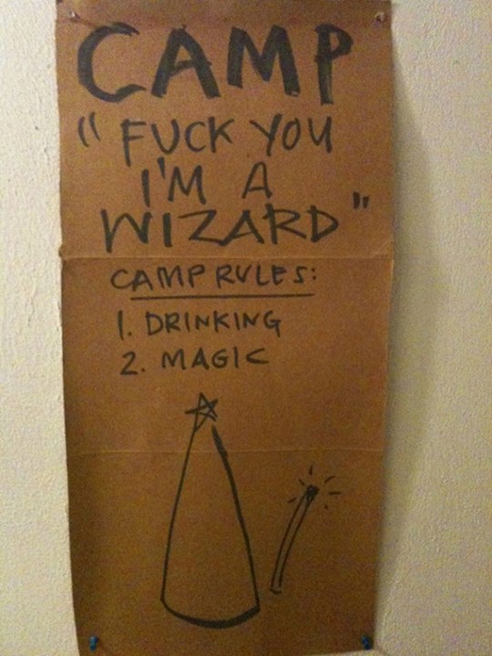 Piece of cardboard on which is written -- Camp 'Fuck You I'm a Wizard' Camp Rules: 1. Drinking, 2. Magic (and then there's a sketch of a pointy wizard hat and wand)